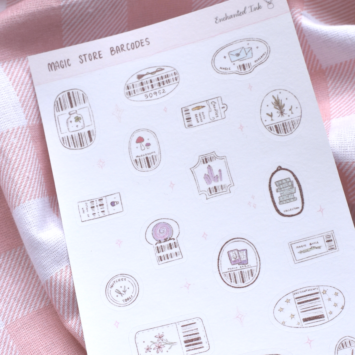 Sheet of decorative stickers with barcodes and illustrations on a pink checkered fabric background