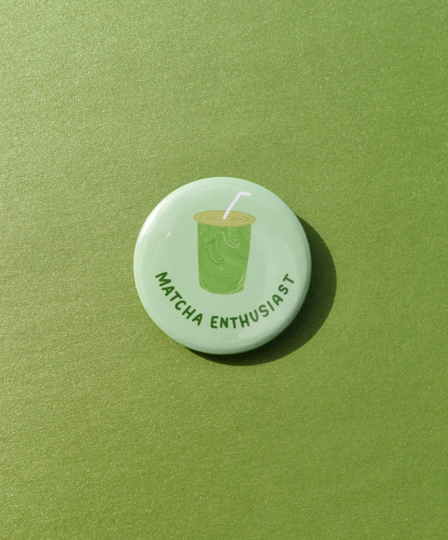 Button badge with 'Matcha Enthusiast' text and matcha green tea cup icon on a green background