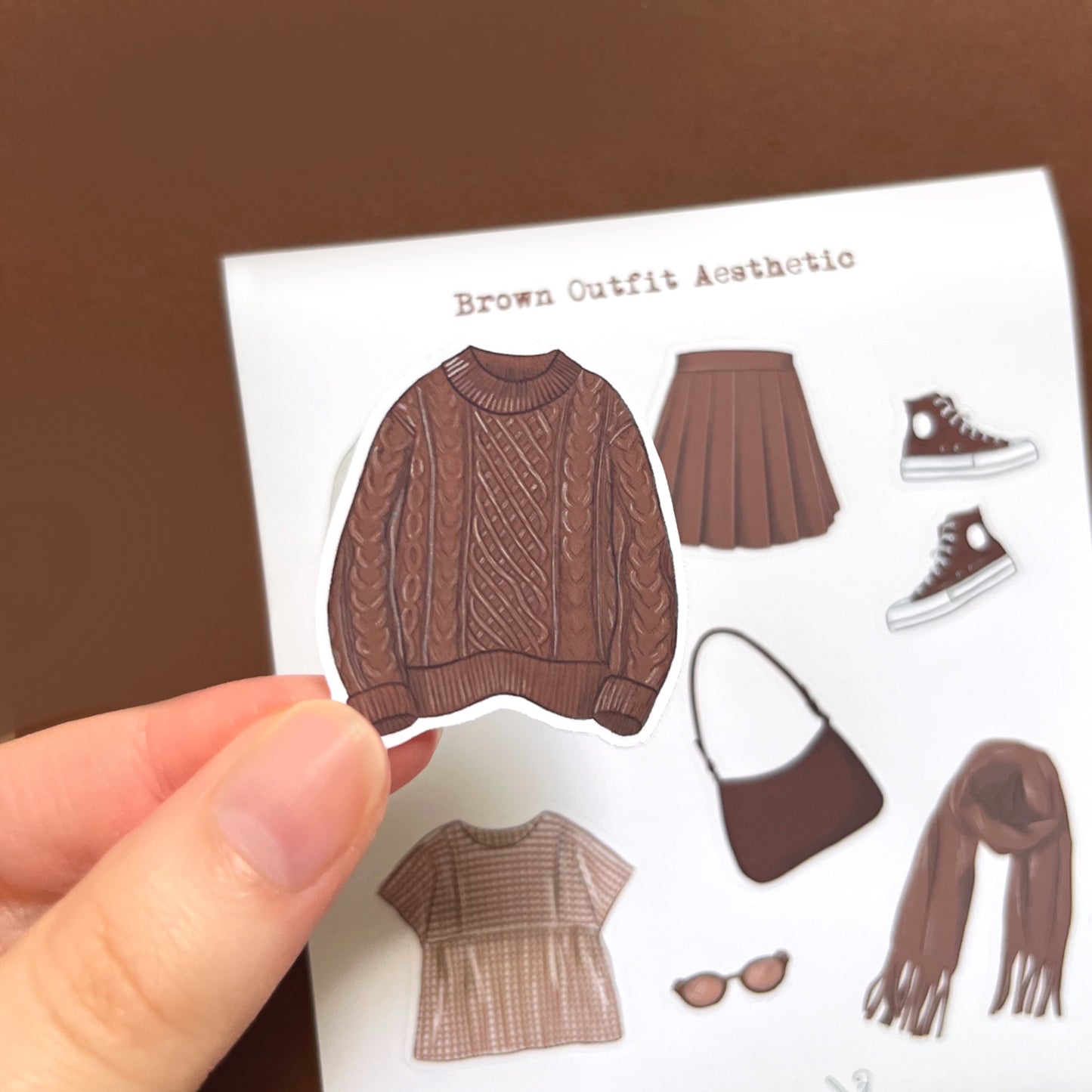 Matte vinyl fashion sticker sheet with brown clothing items for journaling