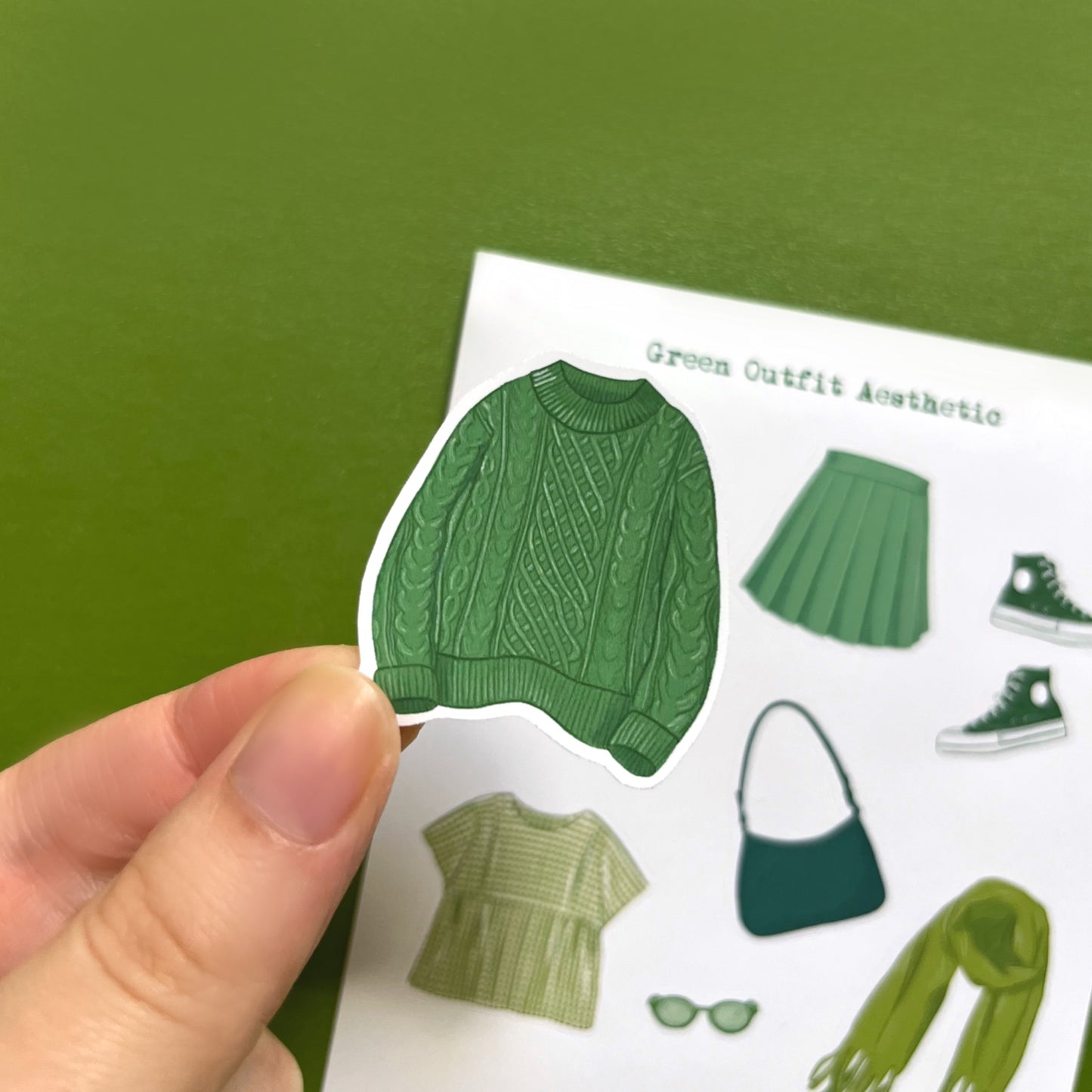 Matte vinyl fashion sticker sheet with green clothing items for journaling