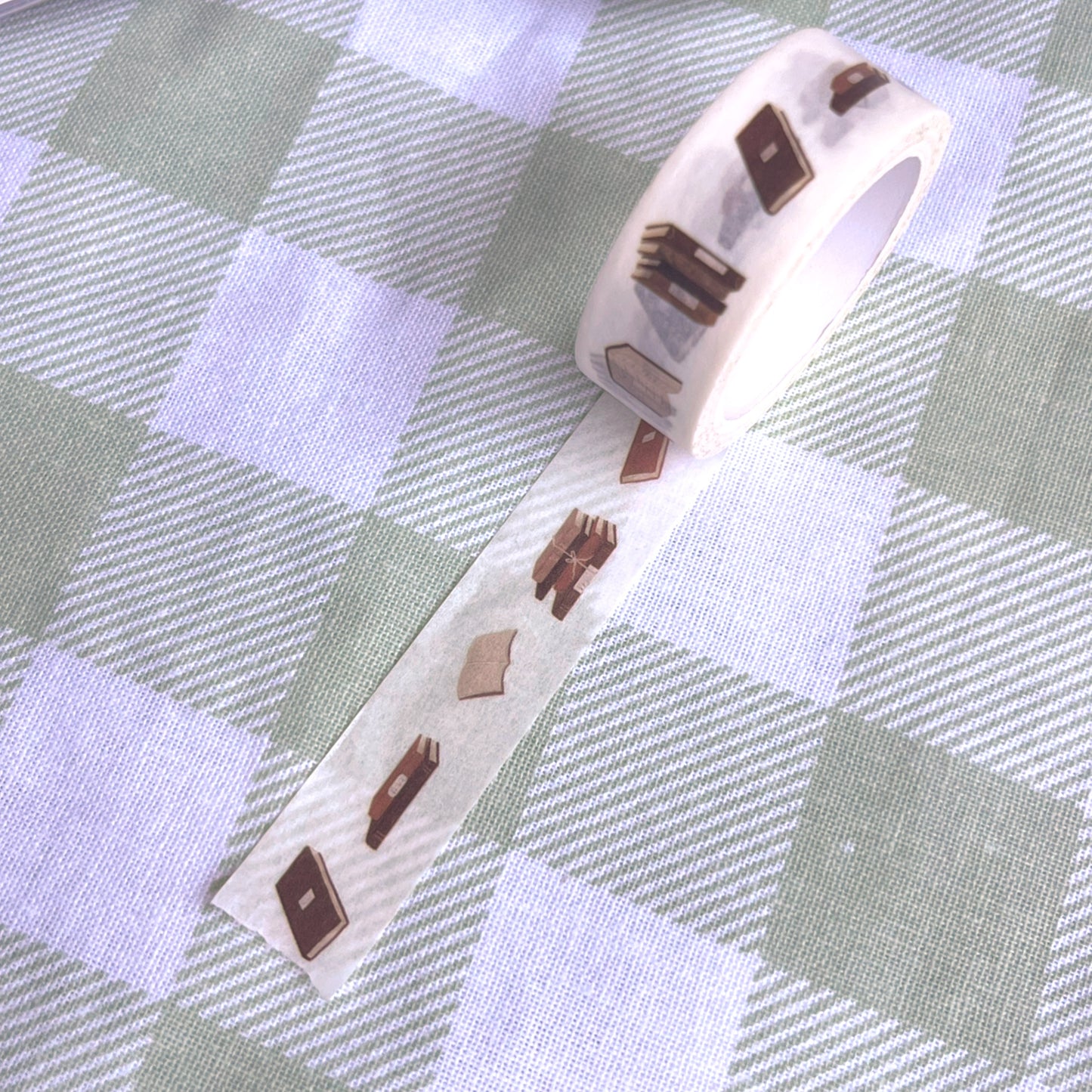 Decorative tape with bookish design on a checkered fabric background