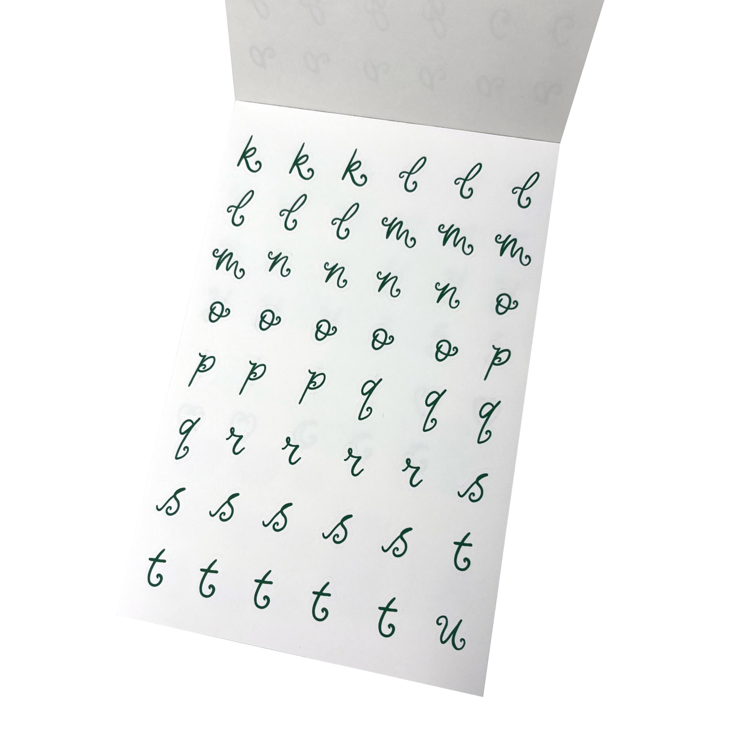 A sheet of green alphabet stickers showing lowercase cursive letters from k through to u. 