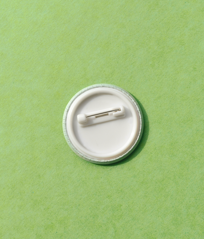White button badge on a green background