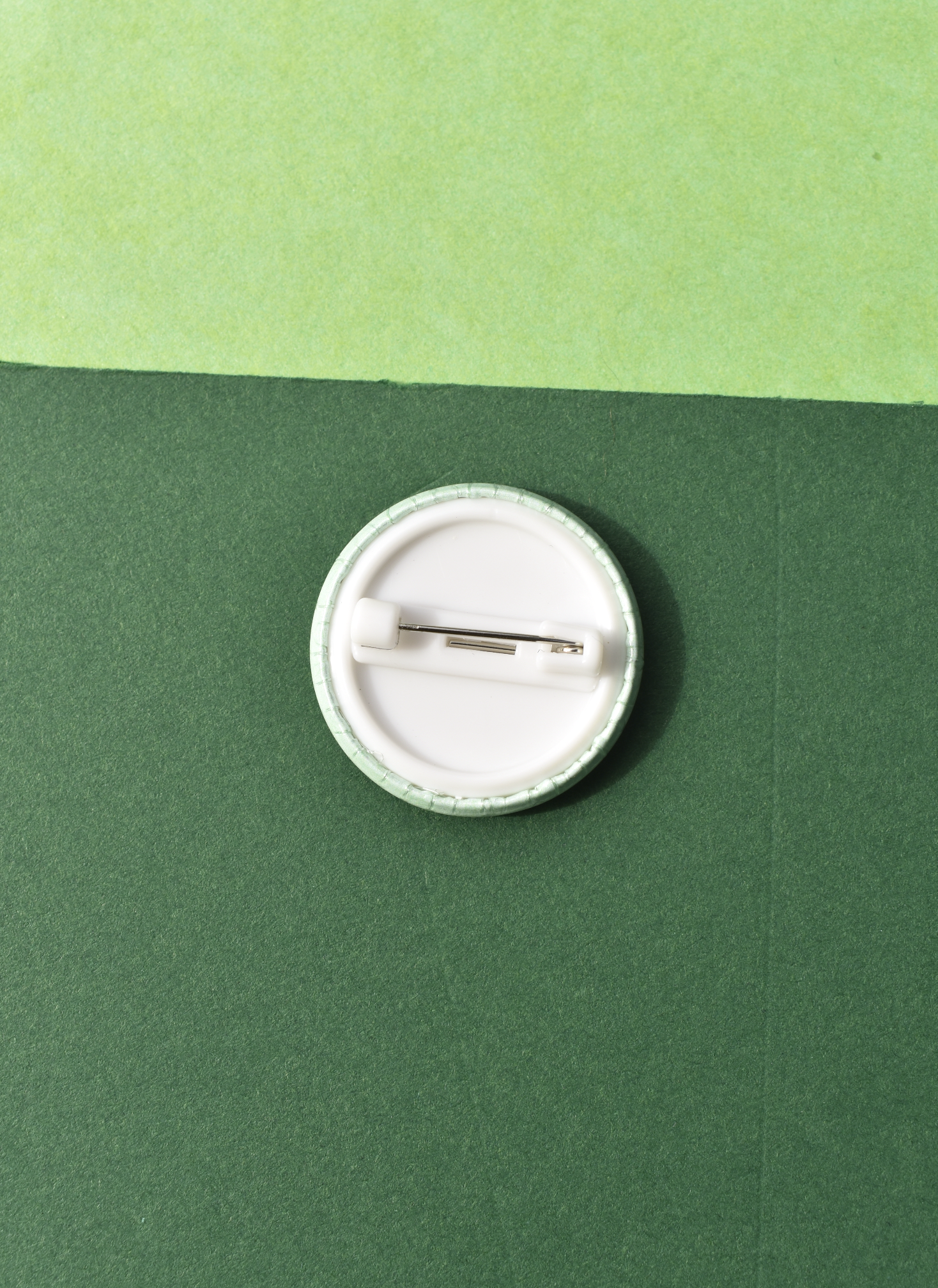White button badge on a green background
