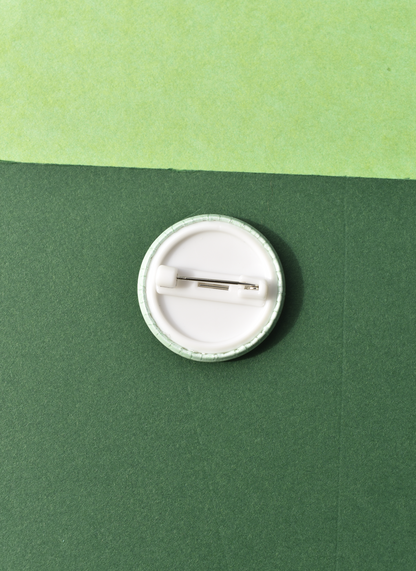 White button badge on a green background