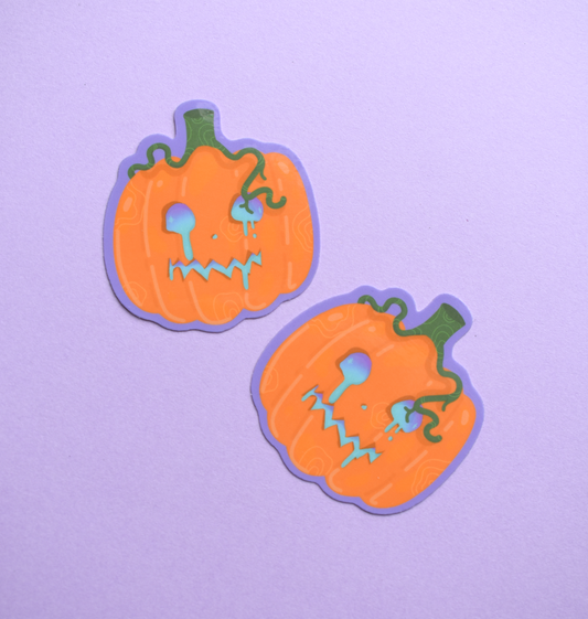 Two pumpkin-shaped stickers with face designs on a purple background