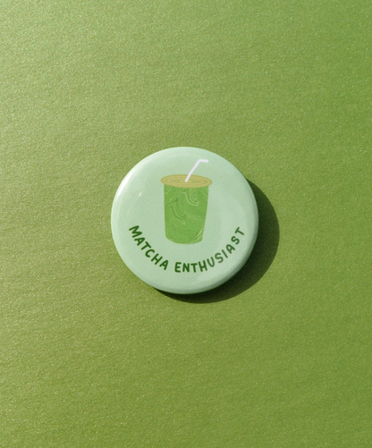 Button badge with 'Matcha Enthusiast' text and matcha green tea cup icon on a green background