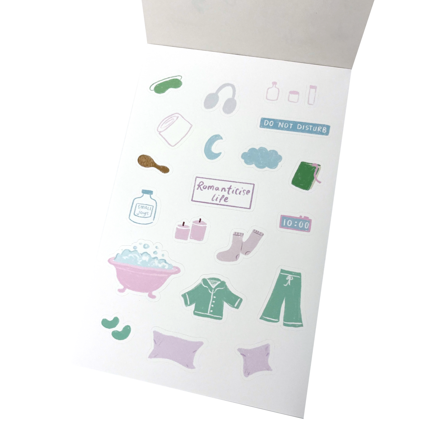 A sheet of cute, minimalist stickers featuring bath and bedroom items like a bathtub, pajamas, socks, headphones, and a 'DO NOT DISTURB' sign.