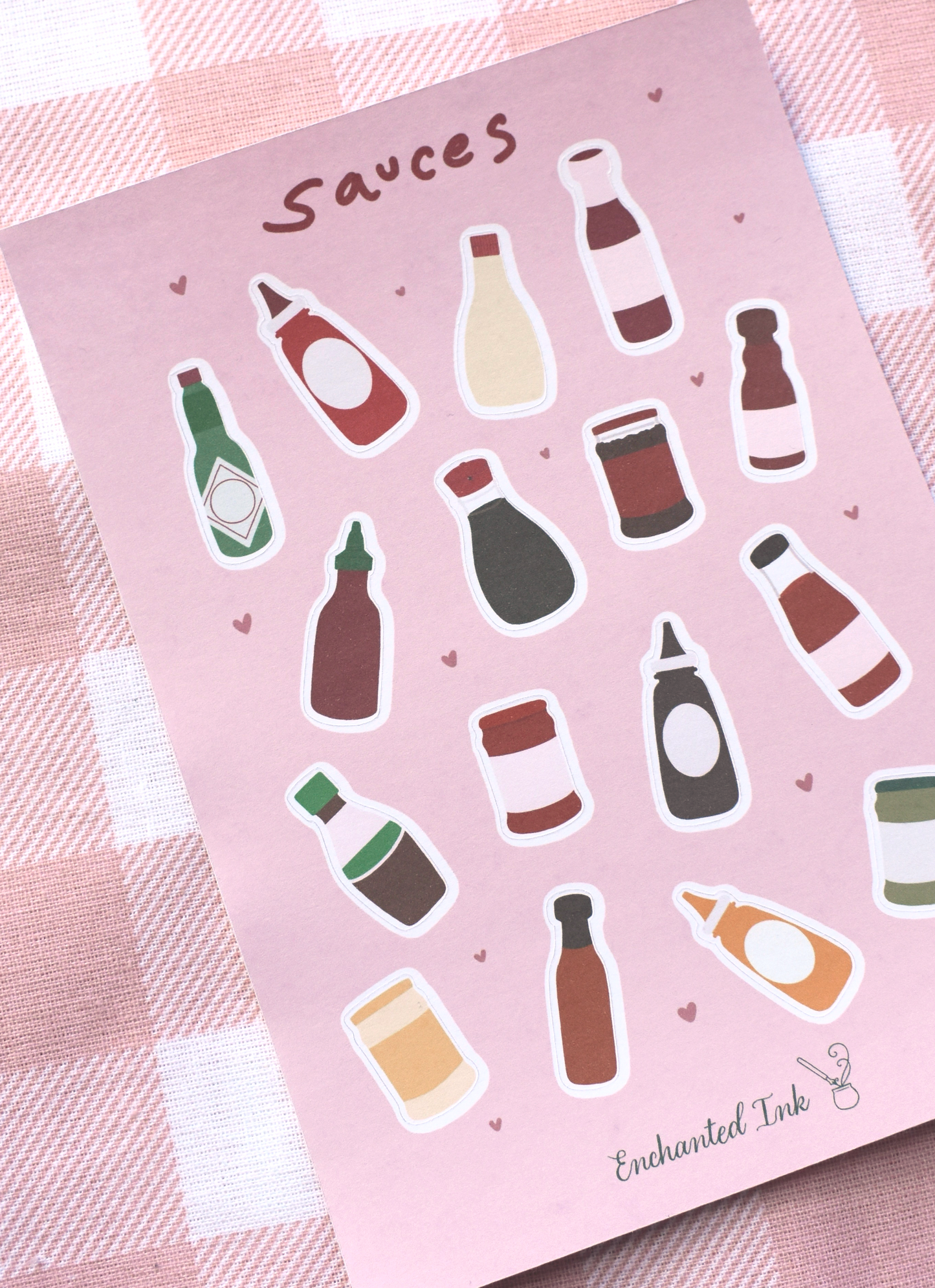 Detailed view of a Sheet of sauce bottle stickers on a pink background with 'Enchanted Ink' branding.