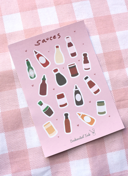 Sheet of sauce bottle stickers on a pink background with a checkered pattern.