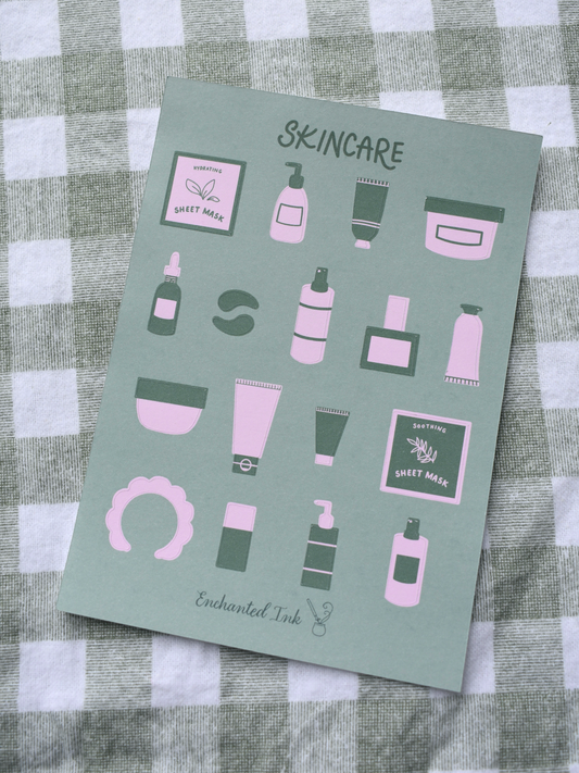 Skincare product illustrations on a green sticker sheet with 'Enchanted Ink' branding, placed on a checkered fabric background.