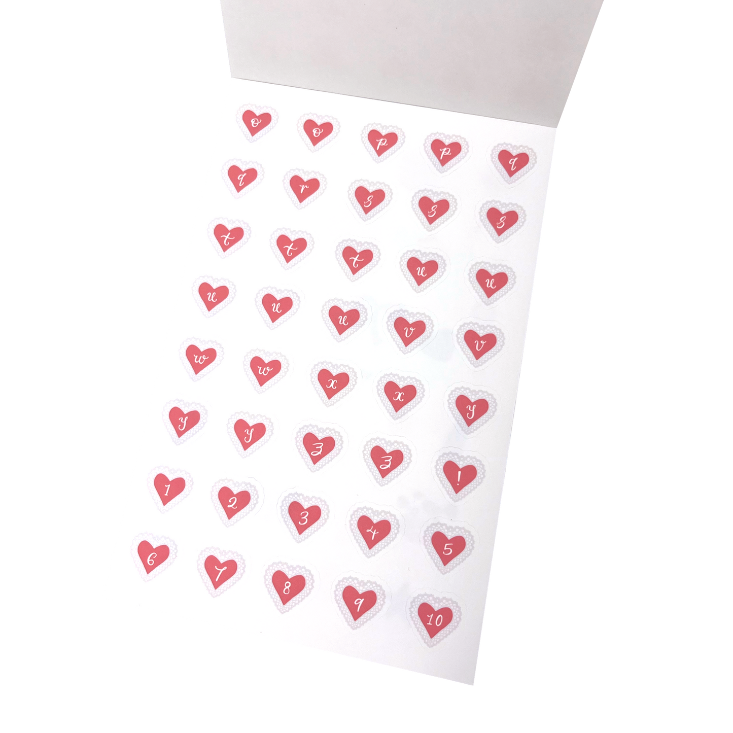 A sheet of small heart-shaped stickers with letters o to z and  numbers 1 through 10 printed inside each heart, arranged on a matte white sticker sheet