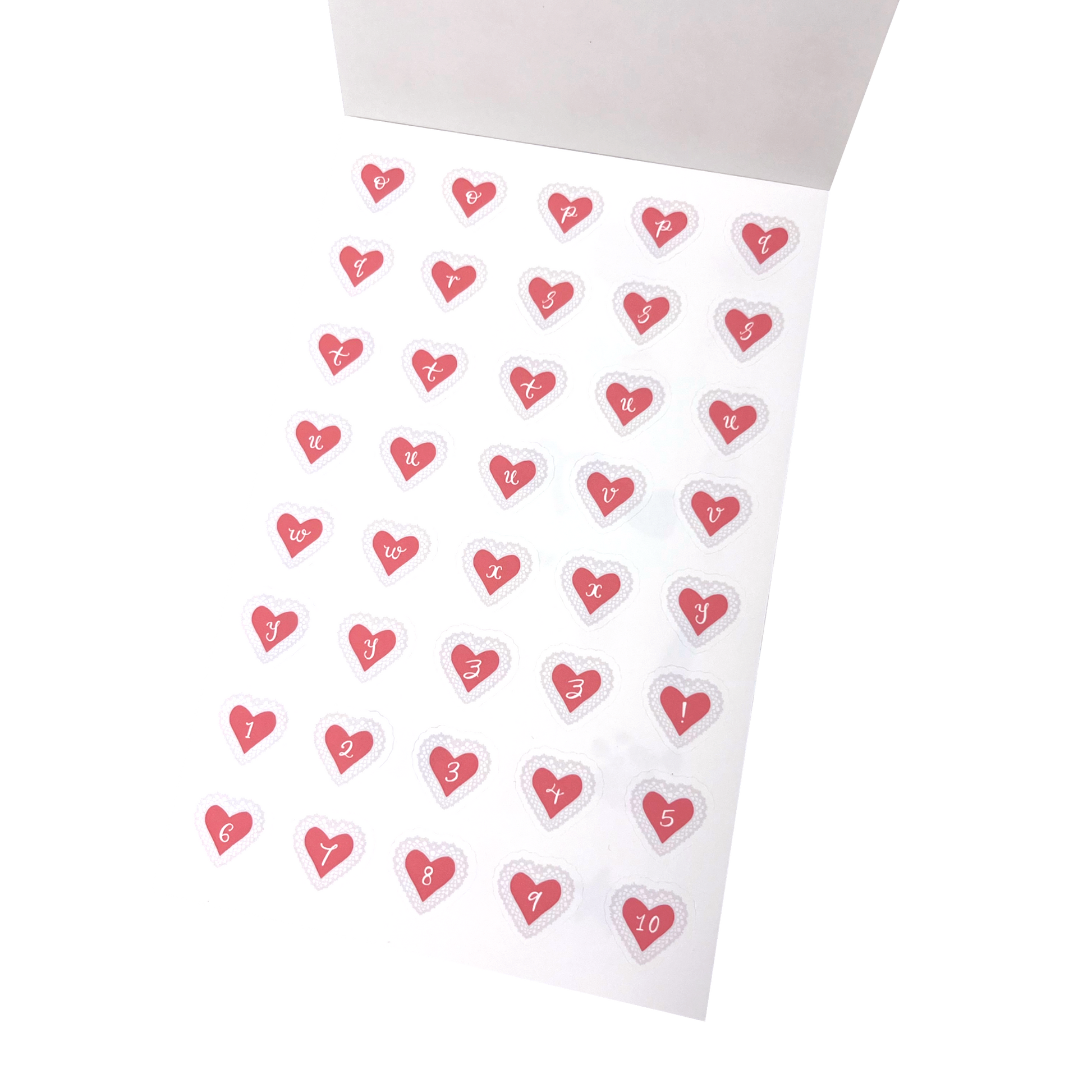 A sheet of small heart-shaped stickers with letters o to z and  numbers 1 through 10 printed inside each heart, arranged on a matte white sticker sheet