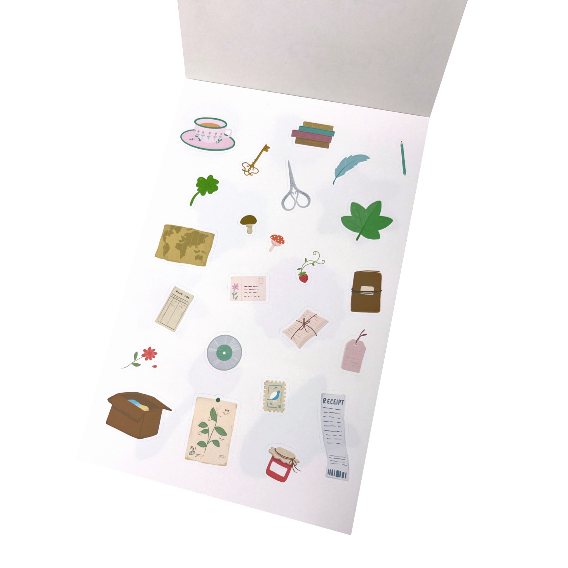 A sheet of illustrated stationery stickers. The stickers include small drawings such as a teacup, books, a key, scissors, a mushroom, a world map, envelopes, a box, a ticket, and small decorative motifs in muted pastel and earthy tones.
