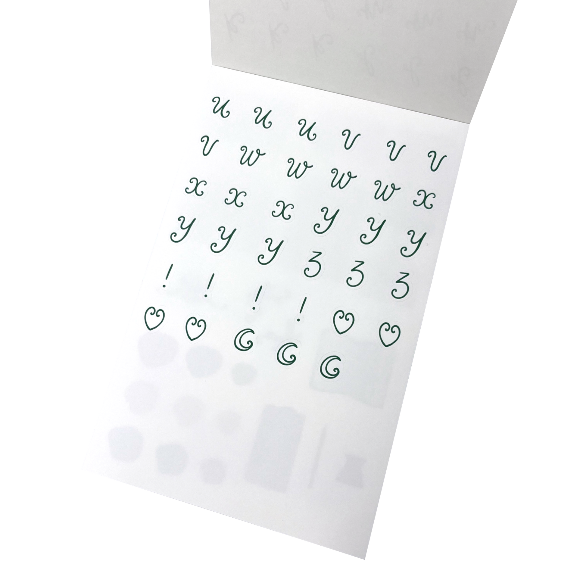 A sheet of green lettering stickers with letters u through to z, and exclamation marks, heart shapes and moons.