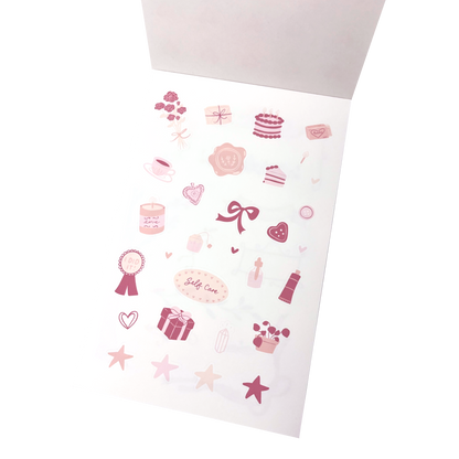 A sticker sheet of pink and pastel stickers, featuring illustrations of cakes, hearts, ribbons, stars, and self care stickers