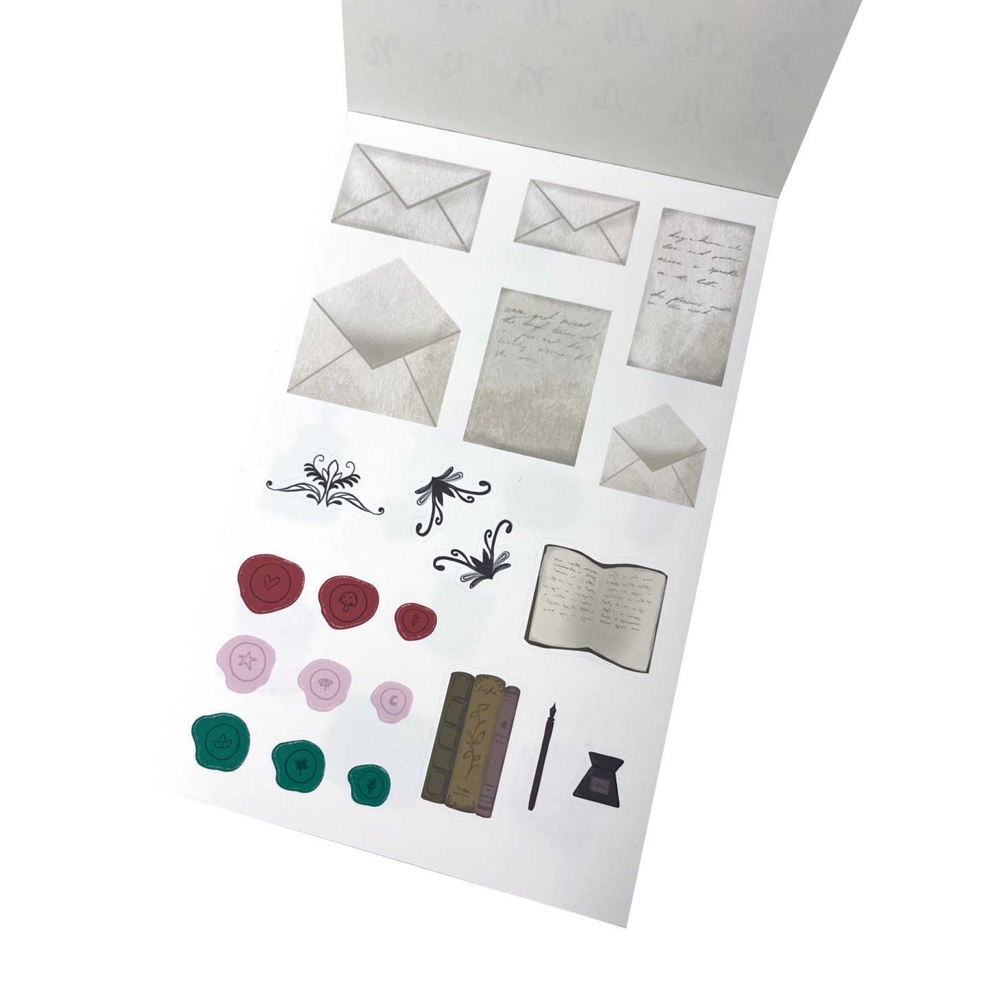 A sheet of decorative stationery stickers, including multiple envelopes, handwritten note cards, floral scroll designs, wax seals in red, pink, and green, an open book, a pen and ink.