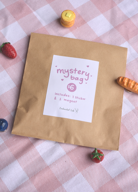 Kraft paper bag labeled 'mystery bag' on a checkered tablecloth with small food magnets around.