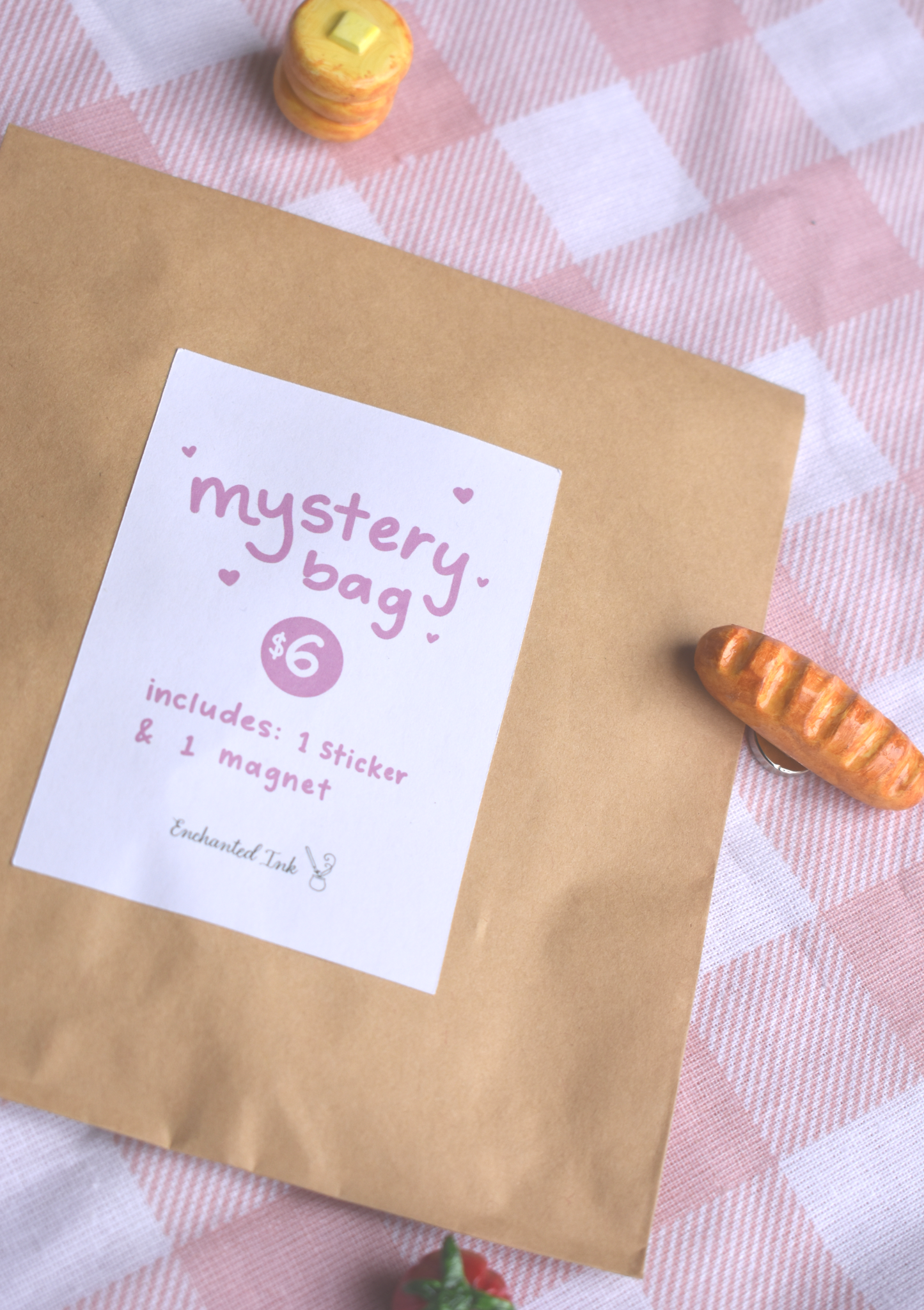 Kraft paper bag with a 'mystery bag' label on a checkered tablecloth.