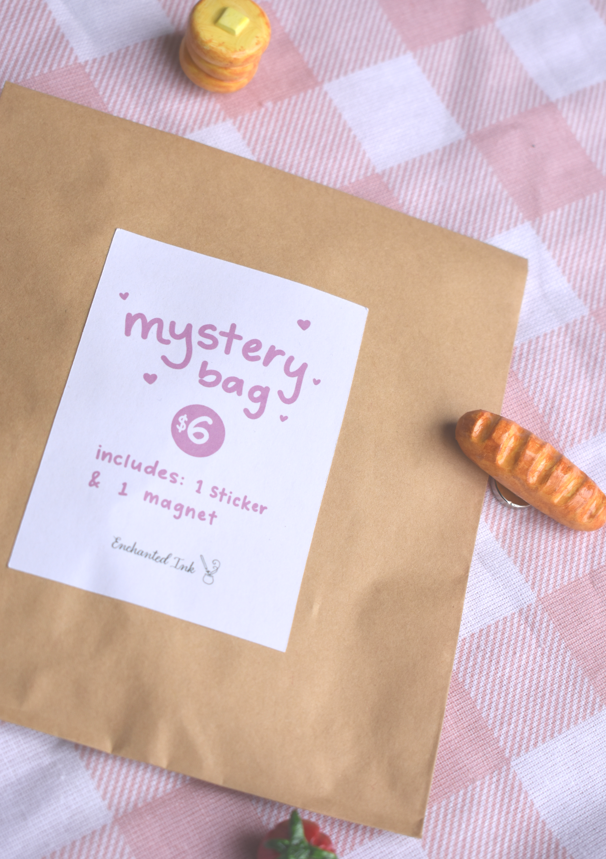 Kraft paper bag with a 'mystery bag' label on a checkered tablecloth.