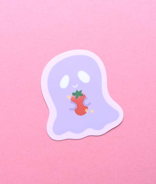 Sticker of a ghost holding a strawberry on a pink background
