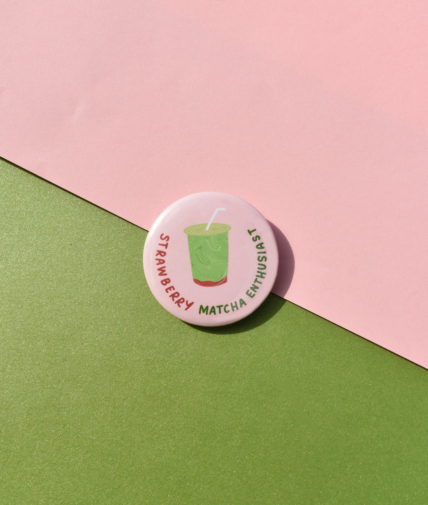 Button badge with 'Strawberry Matcha Enthusiast' text on a pink and green background