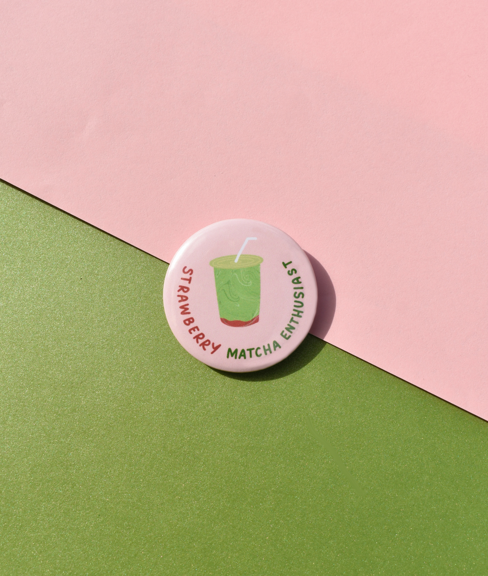 Button badge with 'Strawberry Matcha Enthusiast' text on a pink and green background
