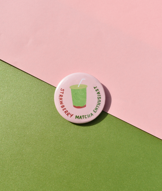 Button badge with 'Strawberry Matcha Enthusiast' text on a pink and green background