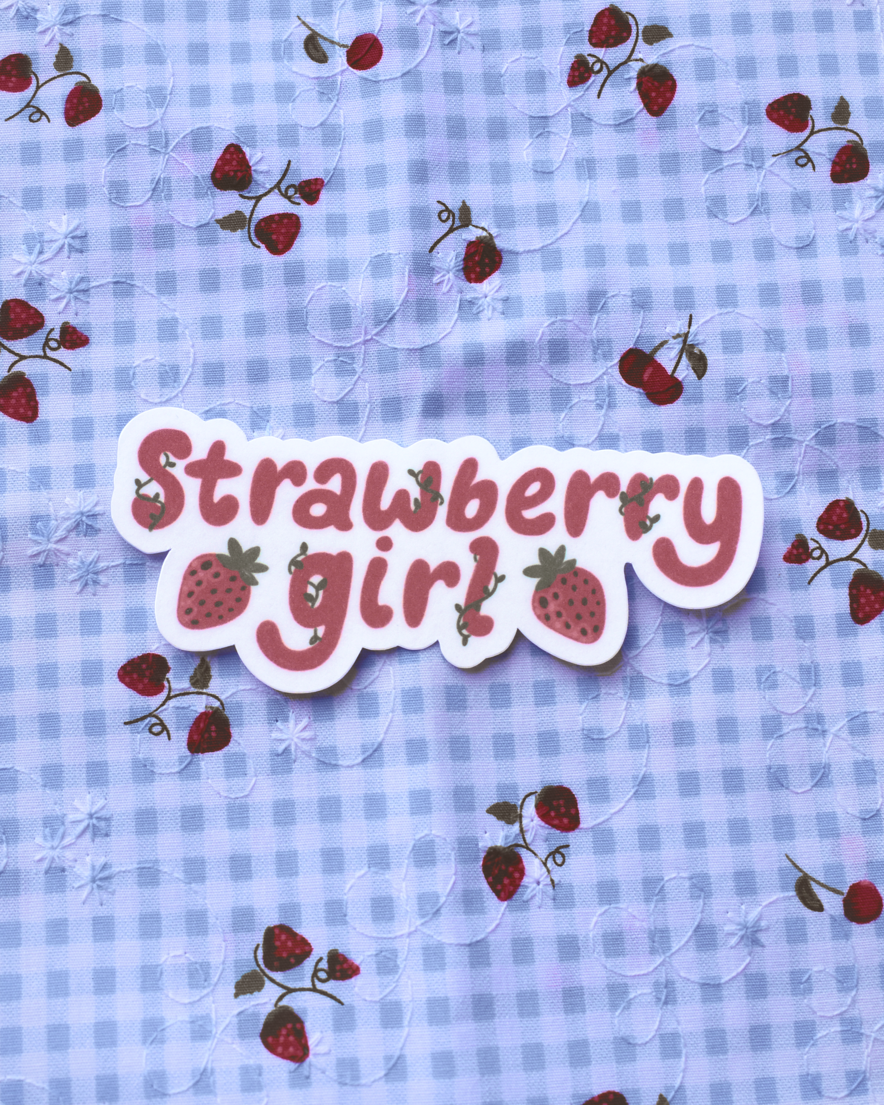 Text 'Strawberry girl' on a blue checkered background with strawberry illustrations