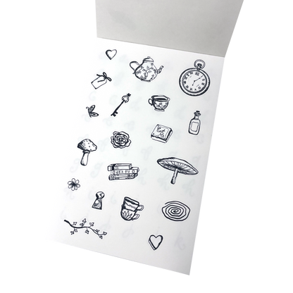 A sticker sheet of black hand-drawn illustrations, inspired by Alice in Wonderland featuring a tea pot, tea cups, a key, mushrooms, books.