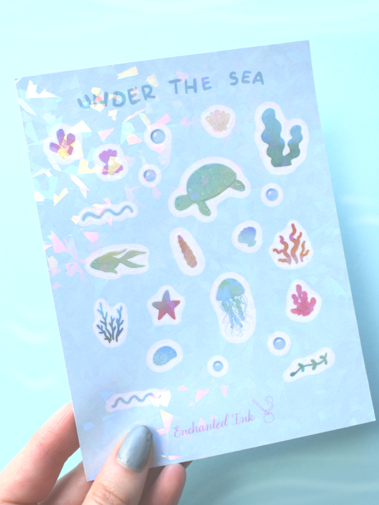 Sticker sheet titled 'Under the Sea' held by a hand with light blue nail polish on a light blue background.