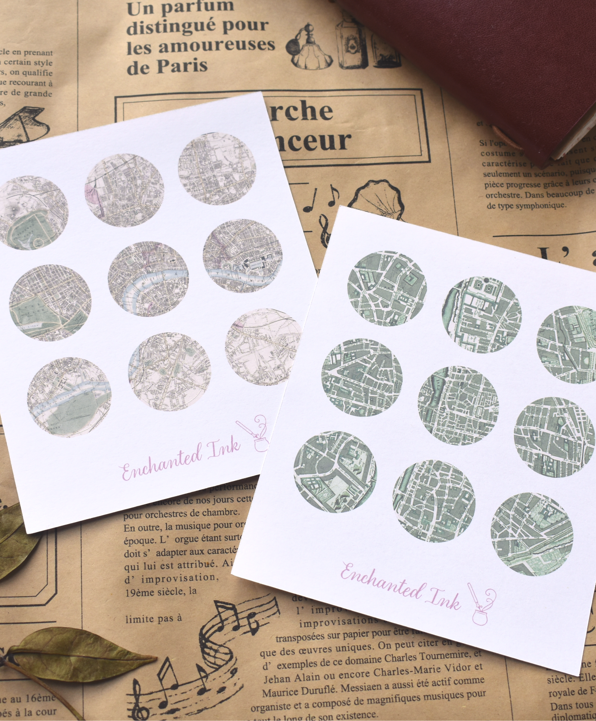 Two sheets of round map stickers with decorative patterns on a newspaper background