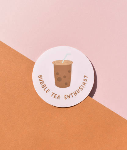 Round sticker with bubble tea illustration and text on a pink and orange background