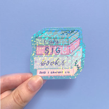 Holographic book lover sticker shown in hand for size reference