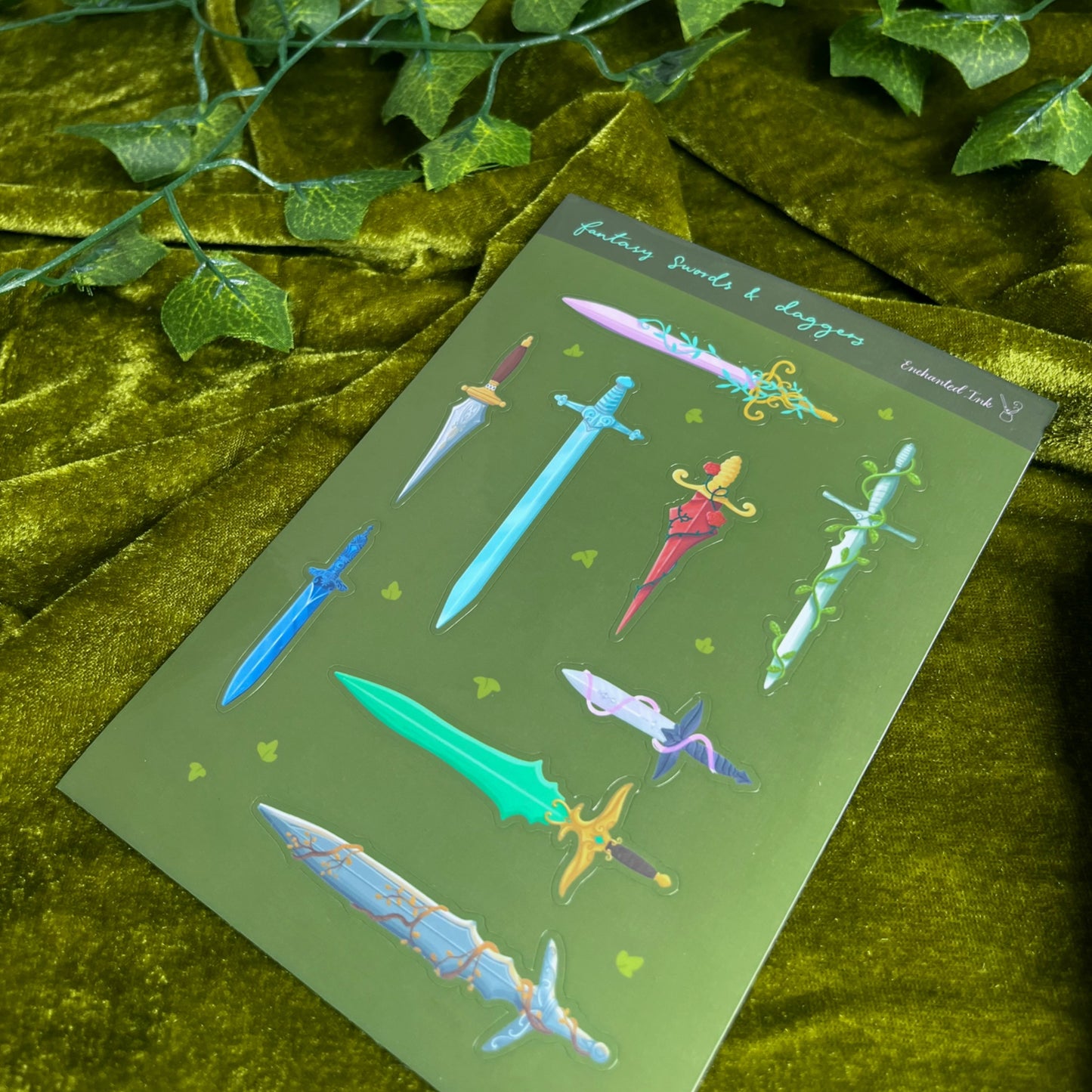 Glossy fantasy sticker sheet featuring illustrated swords and daggers in multiple colours