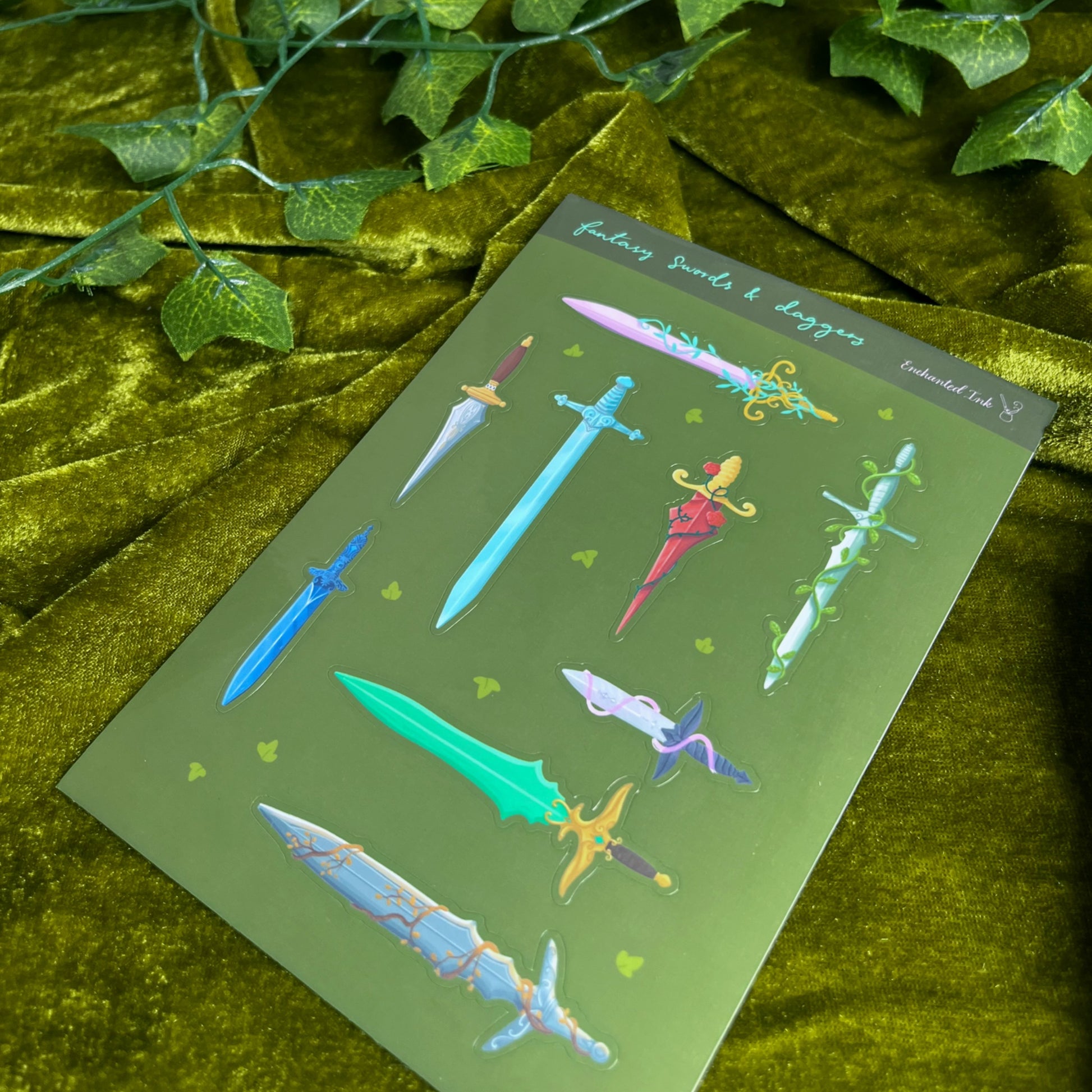 Glossy fantasy sticker sheet featuring illustrated swords and daggers in multiple colours