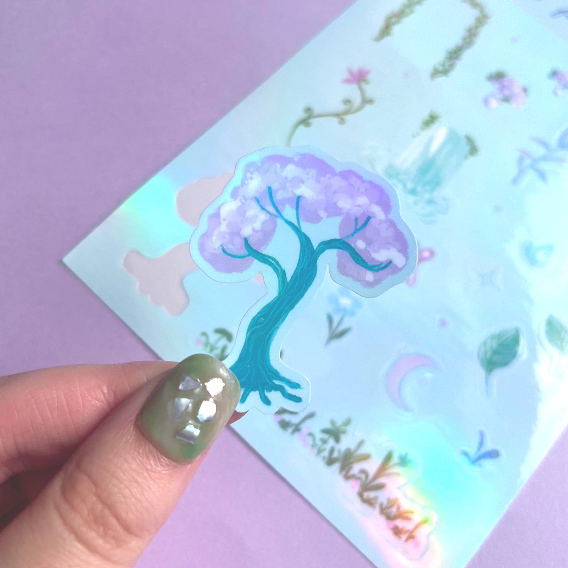 Close-up of holographic enchanted forest vinyl stickers with shimmering purple  details