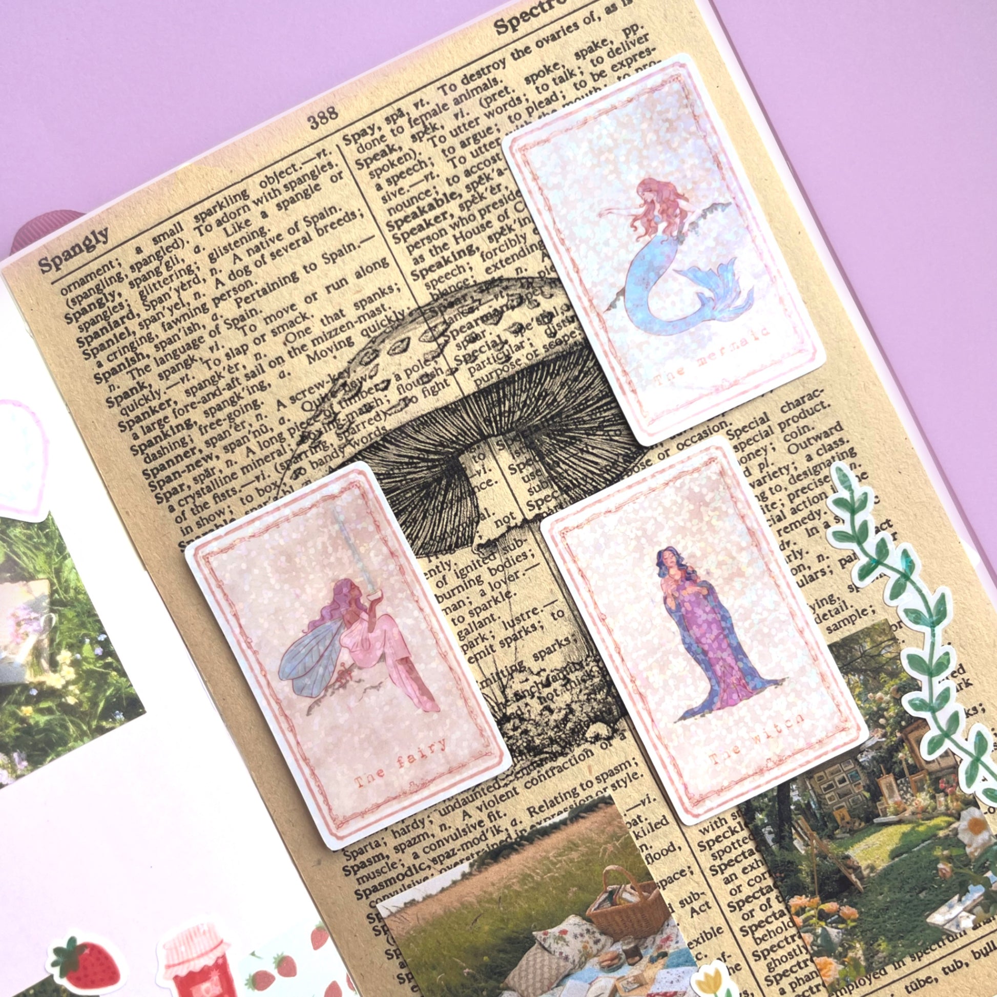 Mystical tarot stickers decorating a journal page, including mermaids, witches, and fairies, showing use in planners and crafts.