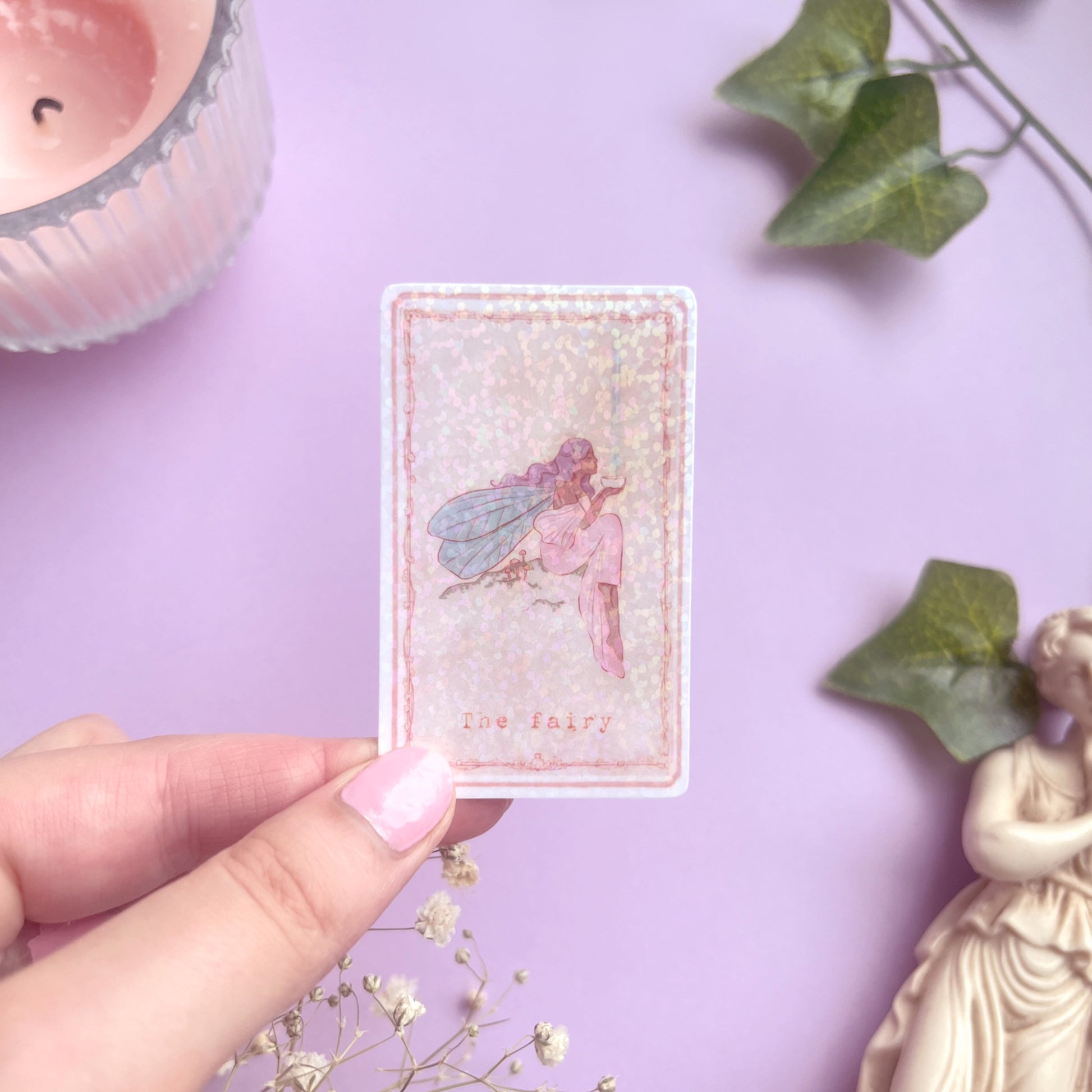 Enchanted Tarot Sticker Fairy held in hand showing 3.8 x 6.2 cm size for reference, perfect for journals and planners.
