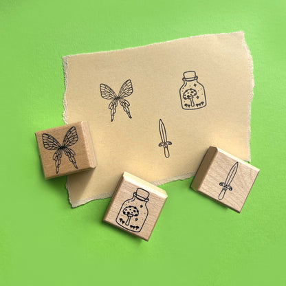 Whimsical rubber stamps with fairy wings enchanted sword and mushroom jar illustrations