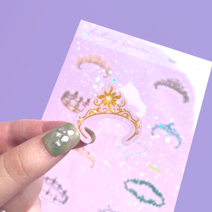Close-up of holographic fantasy crown vinyl stickers with sparkling details on sticker sheet