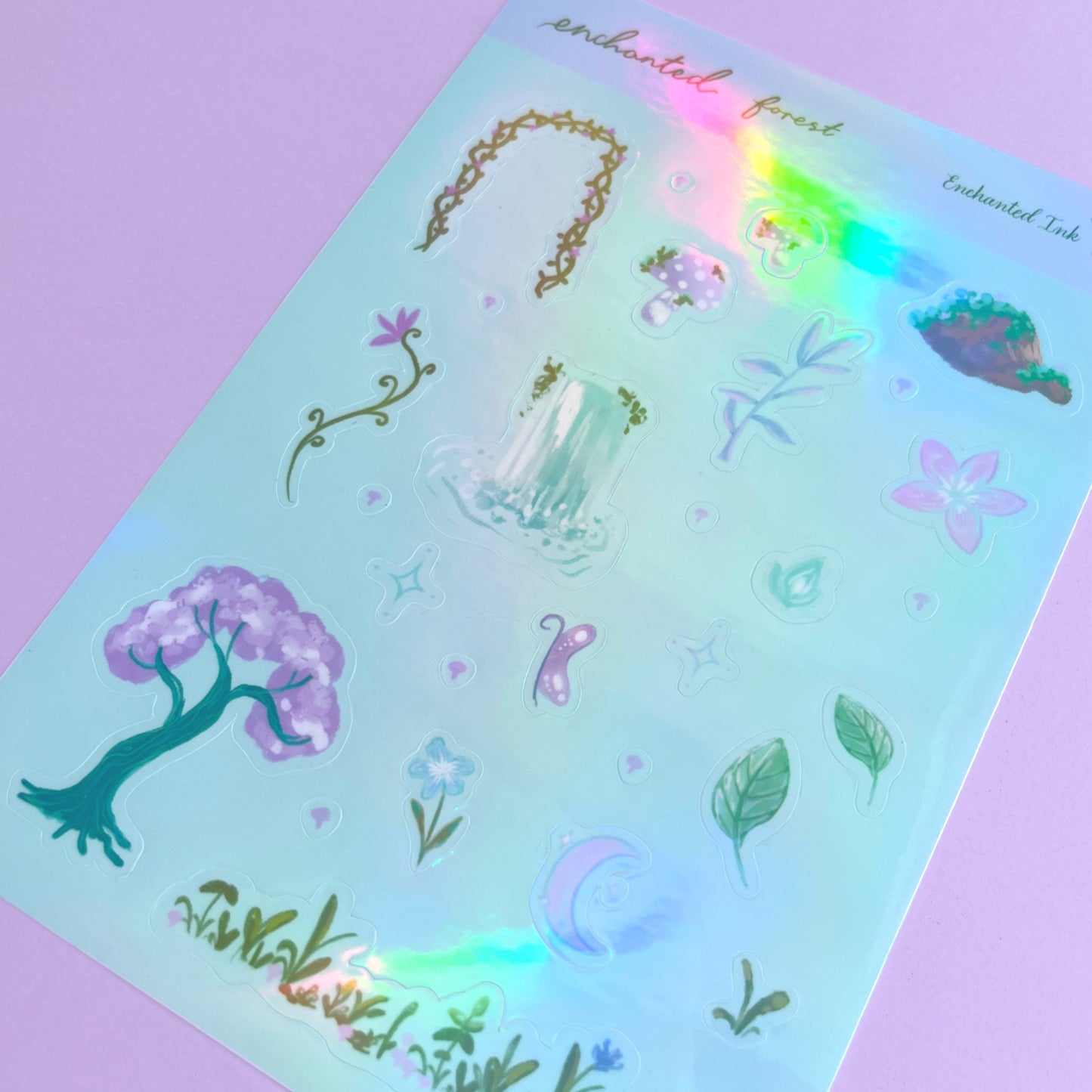 Fantasy forest sticker sheet with purple and green magical woodland designs and holographic shimmer
