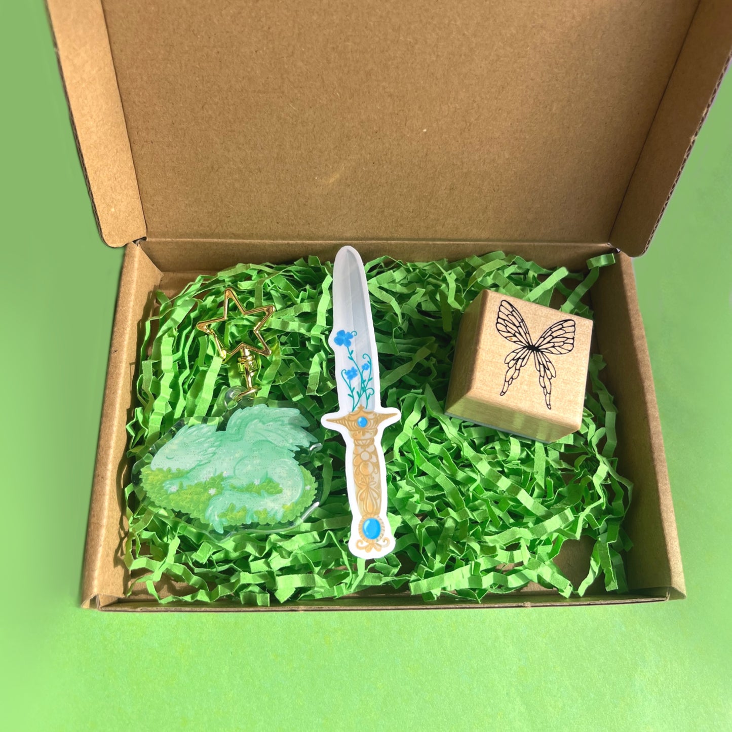 Fantasy gift set featuring dragon keychain fairy stamp and magical sword vinyl sticker