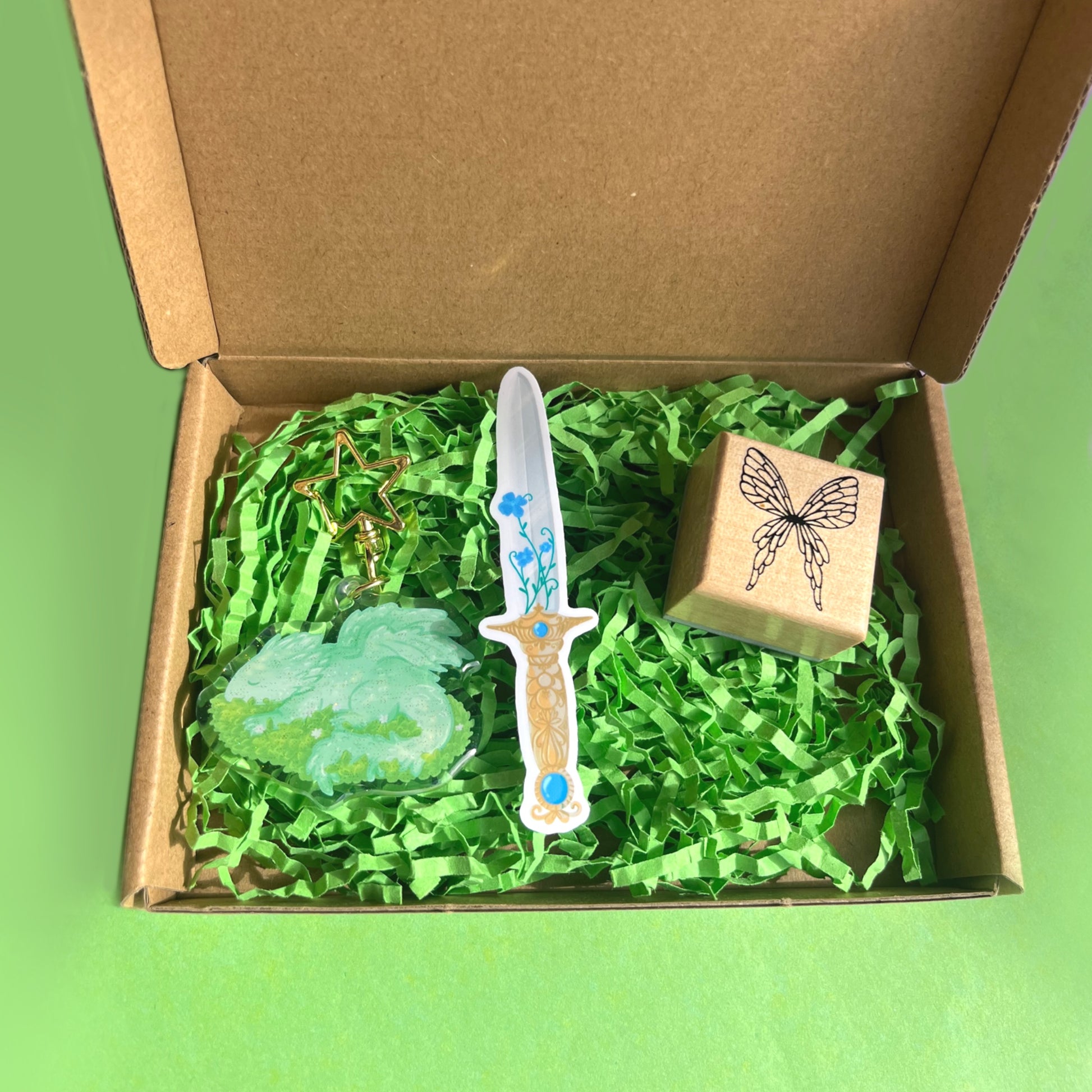 Fantasy gift set featuring dragon keychain fairy stamp and magical sword vinyl sticker