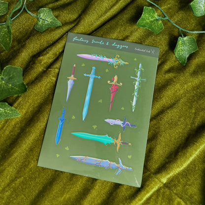 Fantasy swords and daggers glossy vinyl sticker sheet with colourful detailed blades on green background