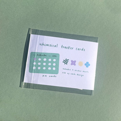 Close-up of whimsical habit tracker cards and mini sticker sheets for planners and journals