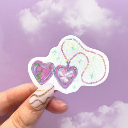 Close-up of holographic heart locket sticker showing rainbow shine