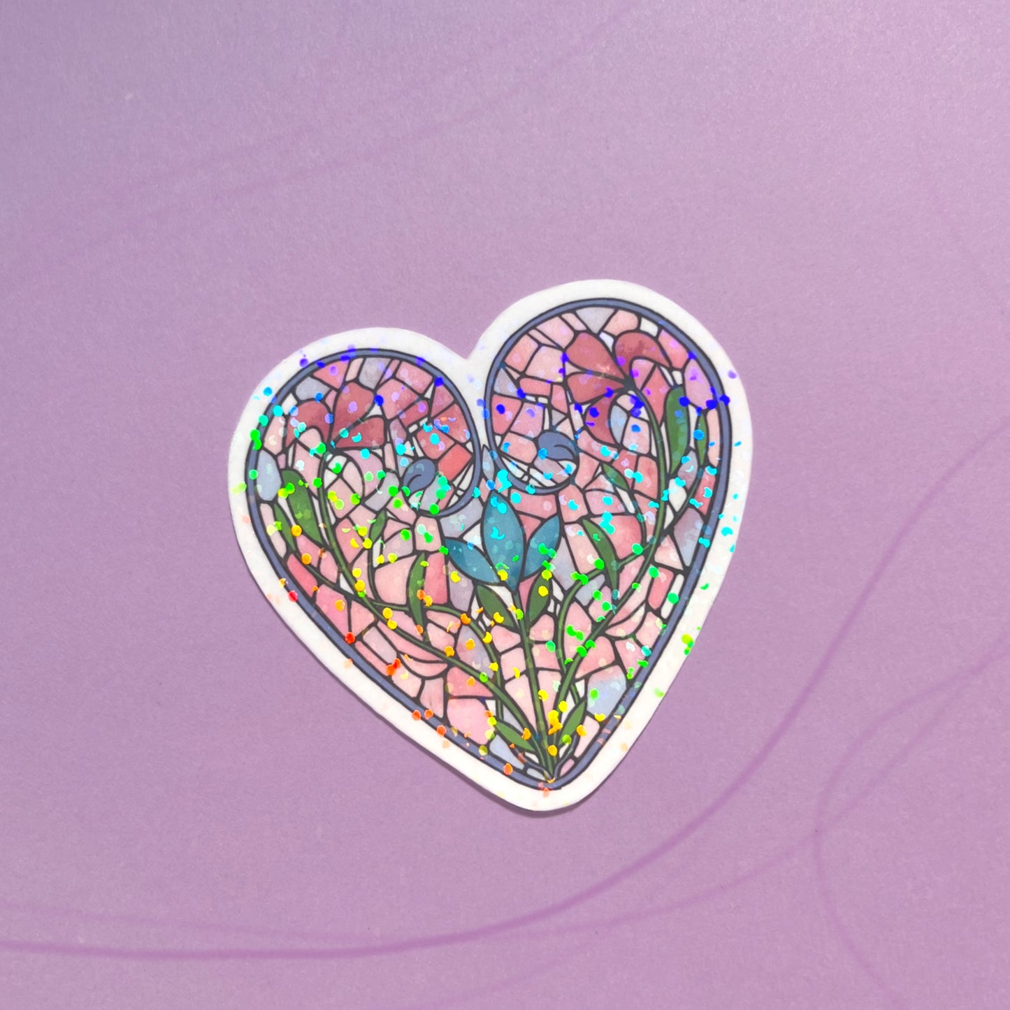 Close-up of holographic stained glass heart sticker reflecting light