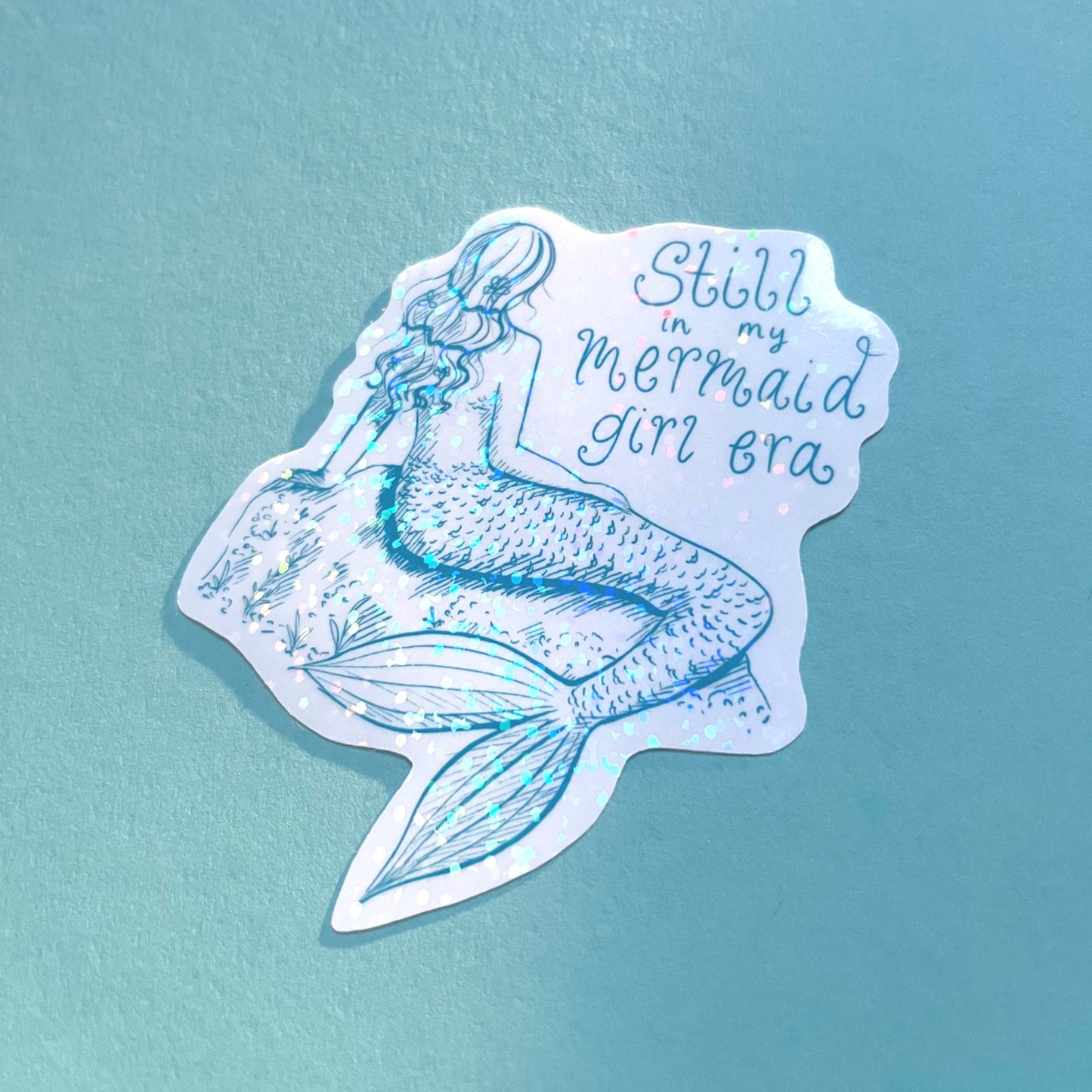 Close-up of handmade holographic mermaid sticker with shimmering finish