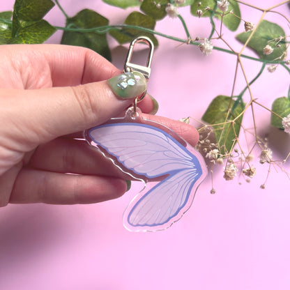 Whimsical acrylic keychain featuring a single fairy wing in pink and purple colours with gold clasp